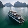 JadeSails luxury cruise ship with modern white design sailing through the limestone islands of Lan Ha Bay.